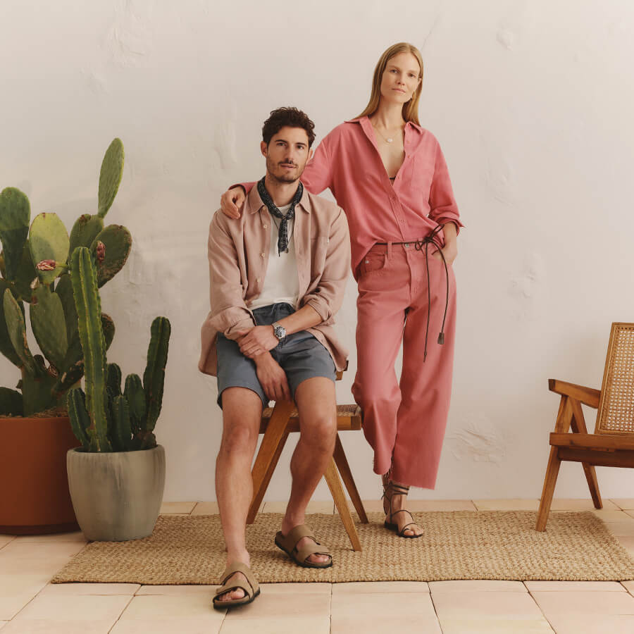 Man and woman in casual outfits standing in a room with a cactus plant