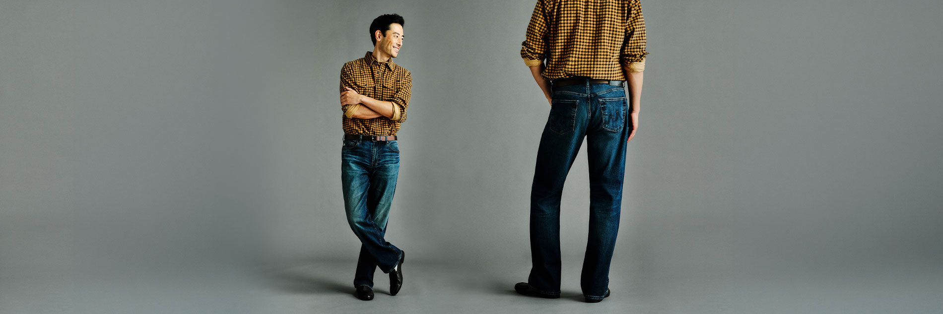 A model is shown wearing dark blue jeans and a brown and yellow gingham shirt