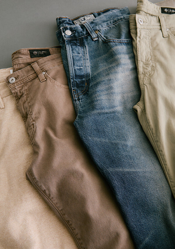 Three pairs of pants in brown, blue, and beige on a neutral background