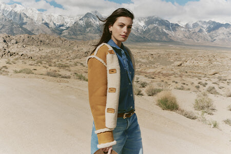 Woman in a desert landscape with mountains in the background