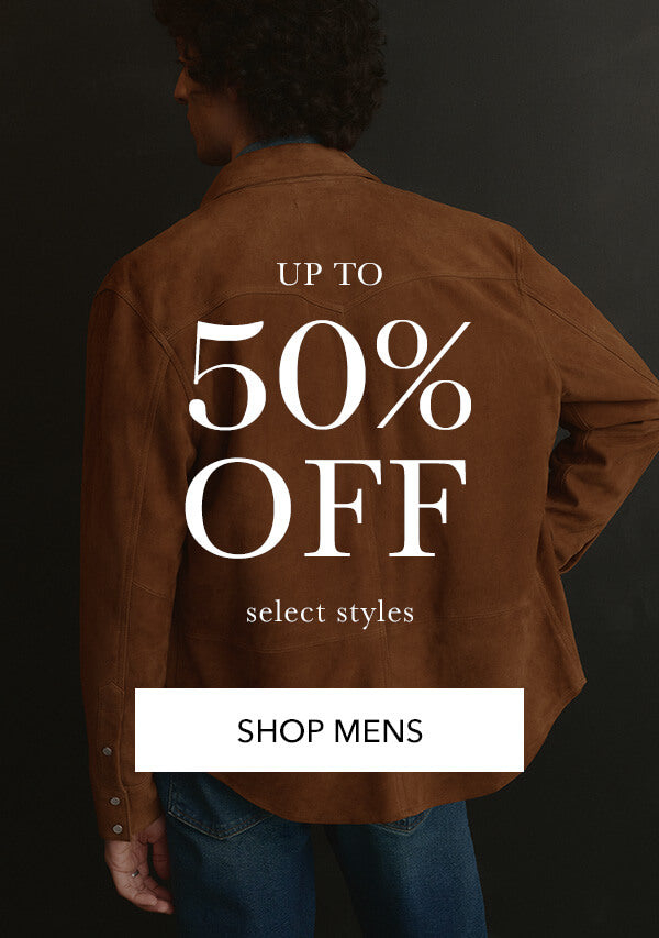 Person wearing a brown jacket with promotional text on the back against a dark background