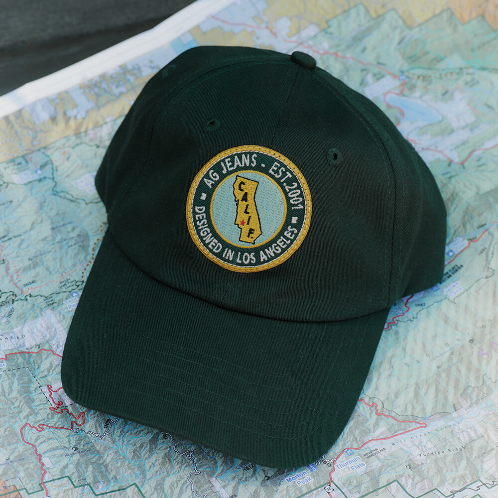 Green cap with a logo on a map background