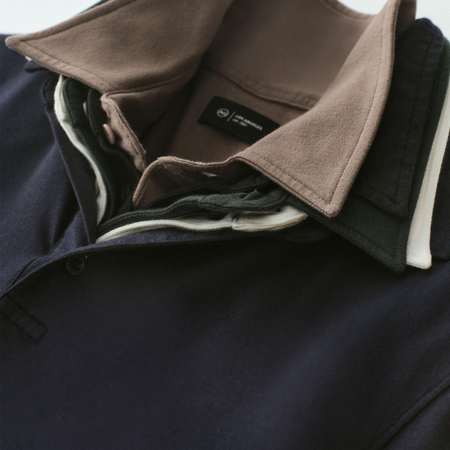 Close-up of a folded jacket with a brand label on a dark background