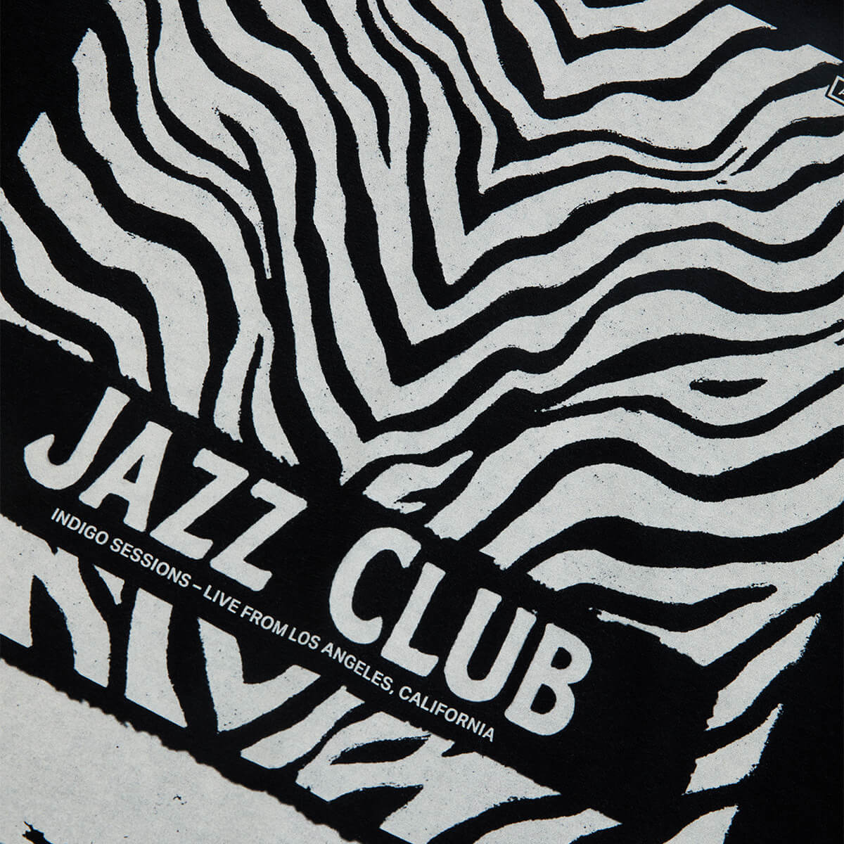 A close-up of a black and white zebra-print graphic with a bold black banner reading 'JAZZ CLUB' and smaller text 'INDIGO SESSIONS - LIVE FROM LOS ANGELES, CALIFORNIA'.