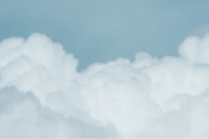 AG Cloud Soft Denim™ - A bright blue sky with white clouds.