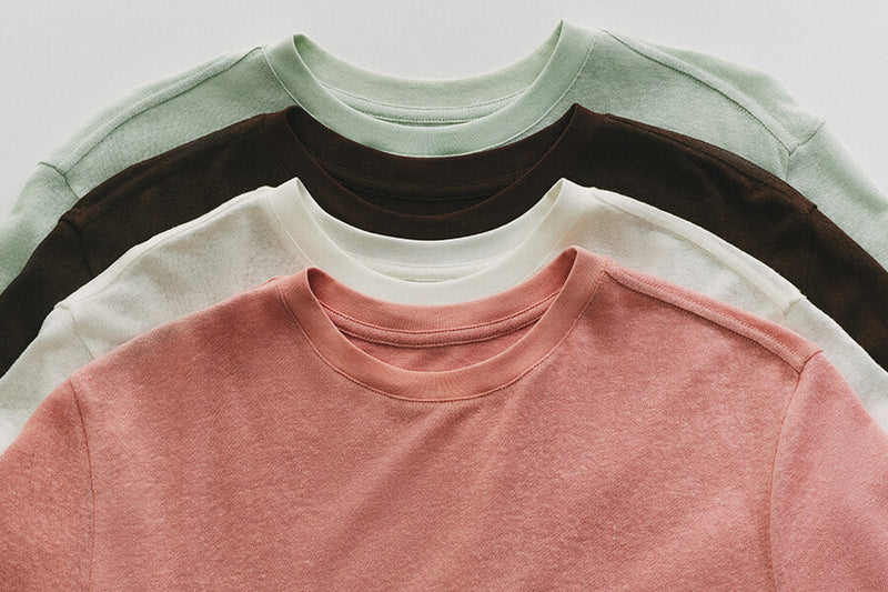Linen - Three linen shirts in white, green, brown, and pink overlapping each other