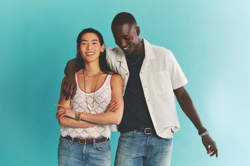 A man and a woman standing in casual summer attire from the Summer '26 Collection.
