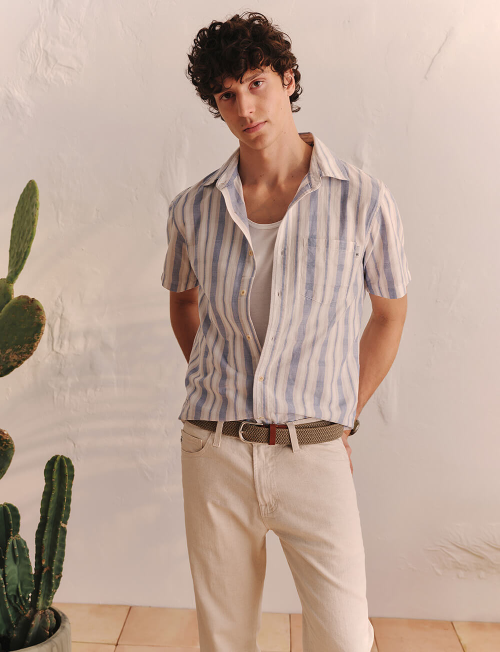 man in white striped top with beige jeans
