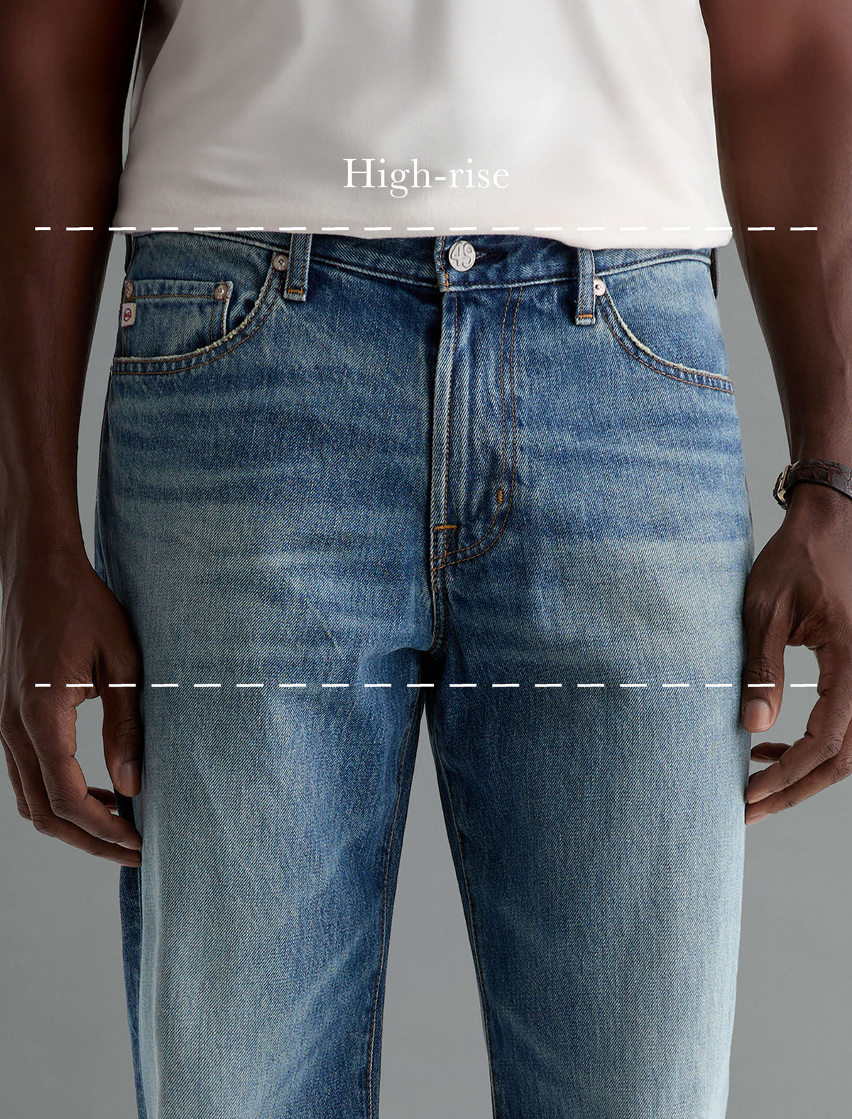 Close-up of a person wearing blue high-rise jeans with a white top, showing the front waistband and upper legs. Dashed lines and the text 'High-rise' indicate the fit style.