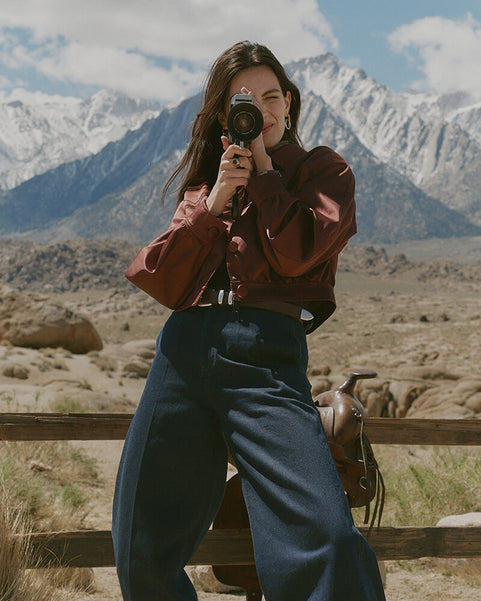 Person taking a photo with mountains in the background