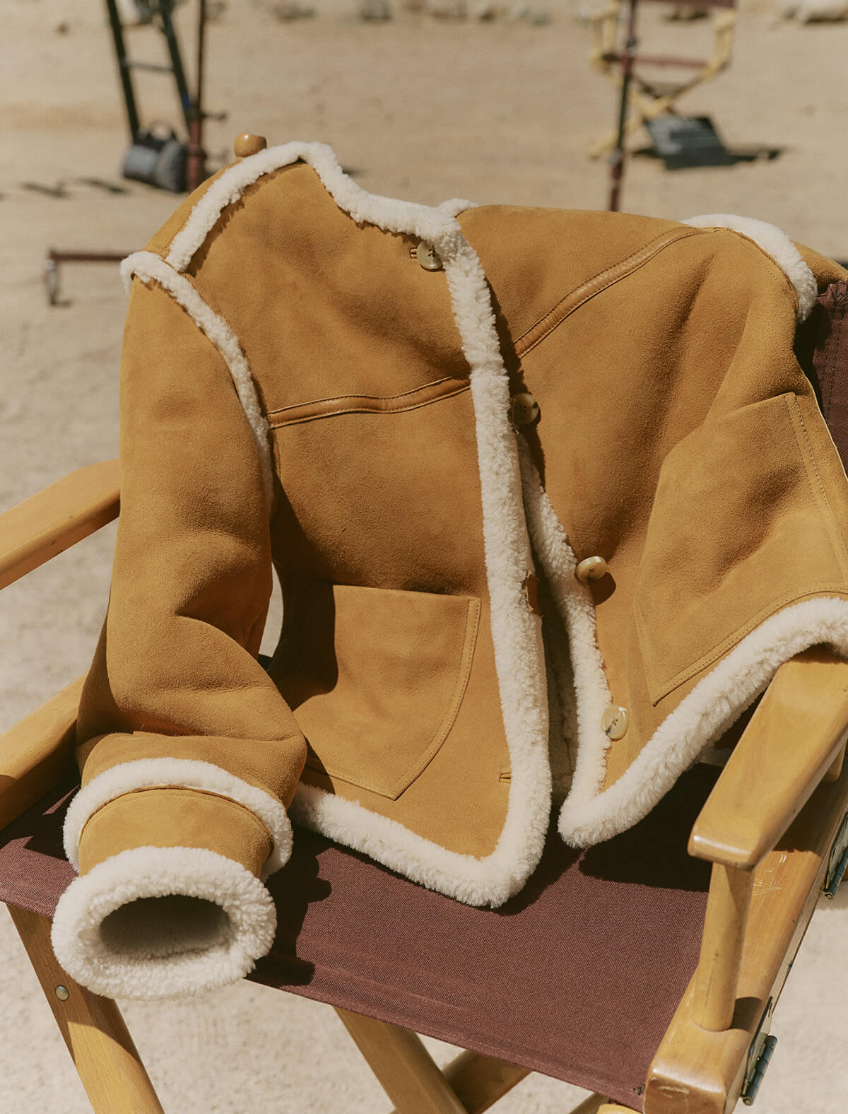 Brown shearling jacket on a director's chair with a desert background