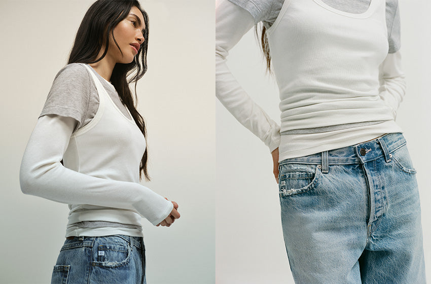Two people wearing white long-sleeve shirts and blue jeans against a plain background