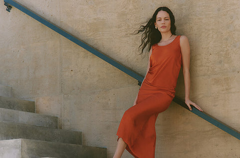 Woman in orange silk tank and orange silk skirt