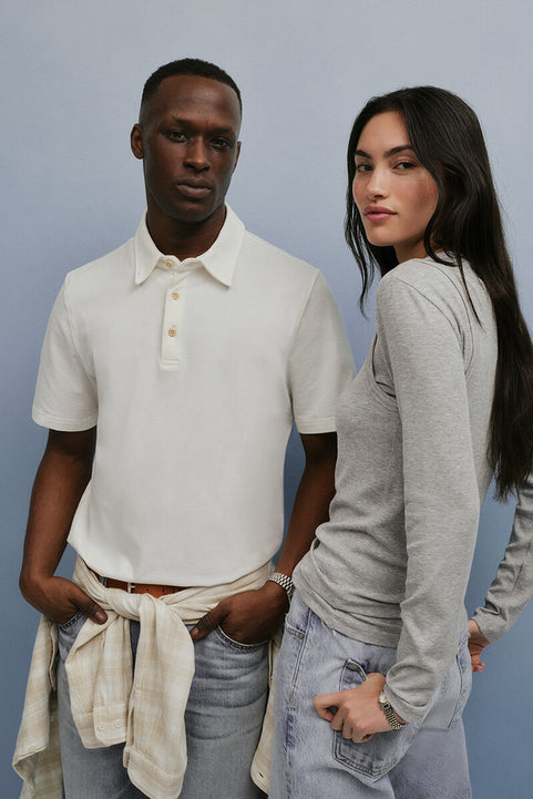 Two people standing side by side against a plain background